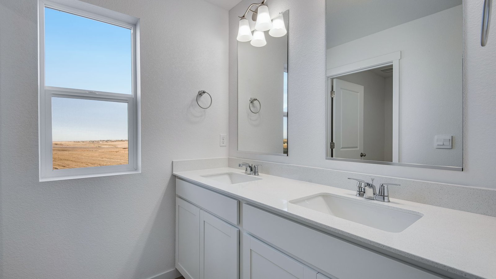 Second bedroom in new home with double sinks