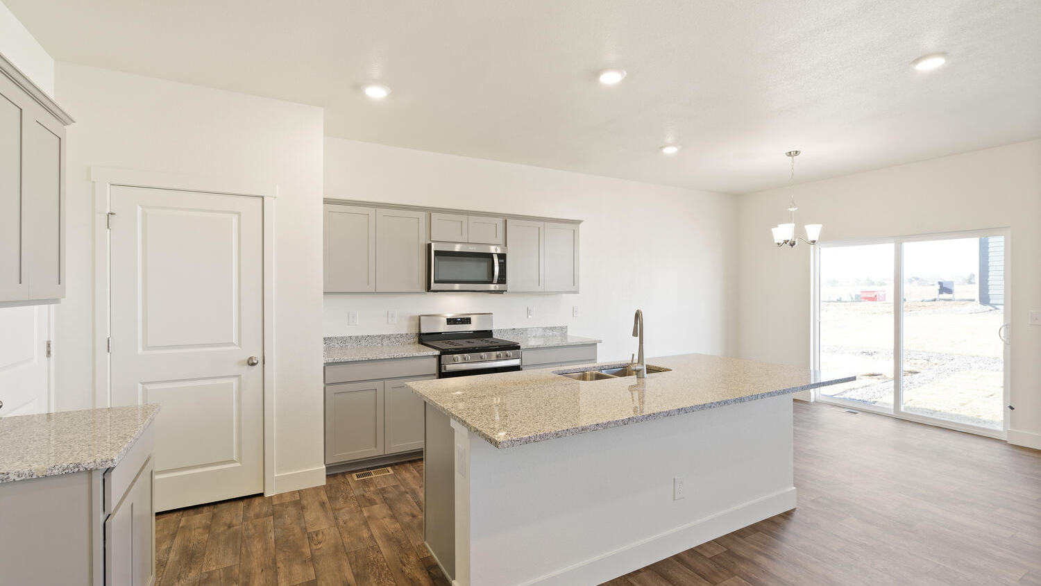 Additional view of kitchen, pantry, and sliding patio door with outdoor access