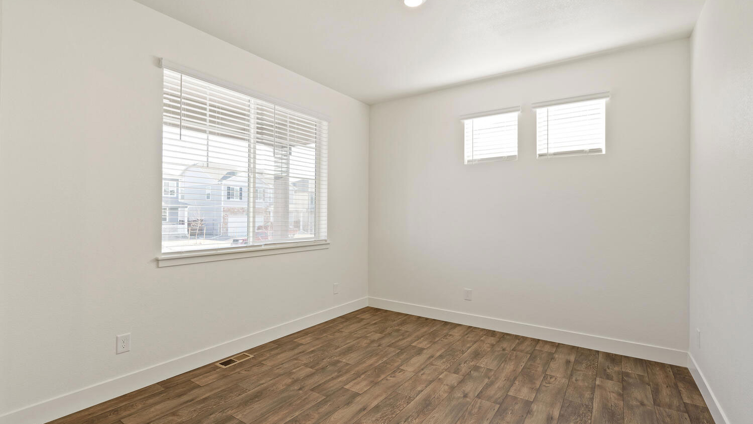 Study near front home entrance with three windows for ample natural light