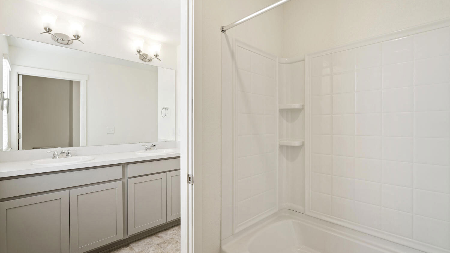 Secondary split bathroom located between additional bedrooms featuring dual sinks, chrome finishes, and shower/tub combo