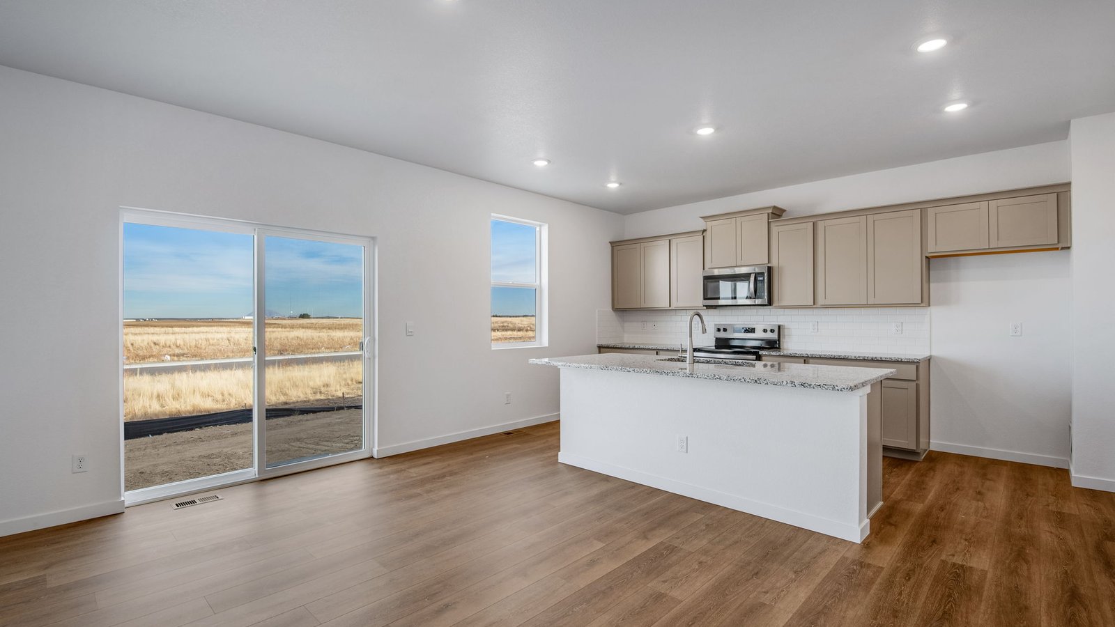 Open concept layout with walk-out access to backyard in new home