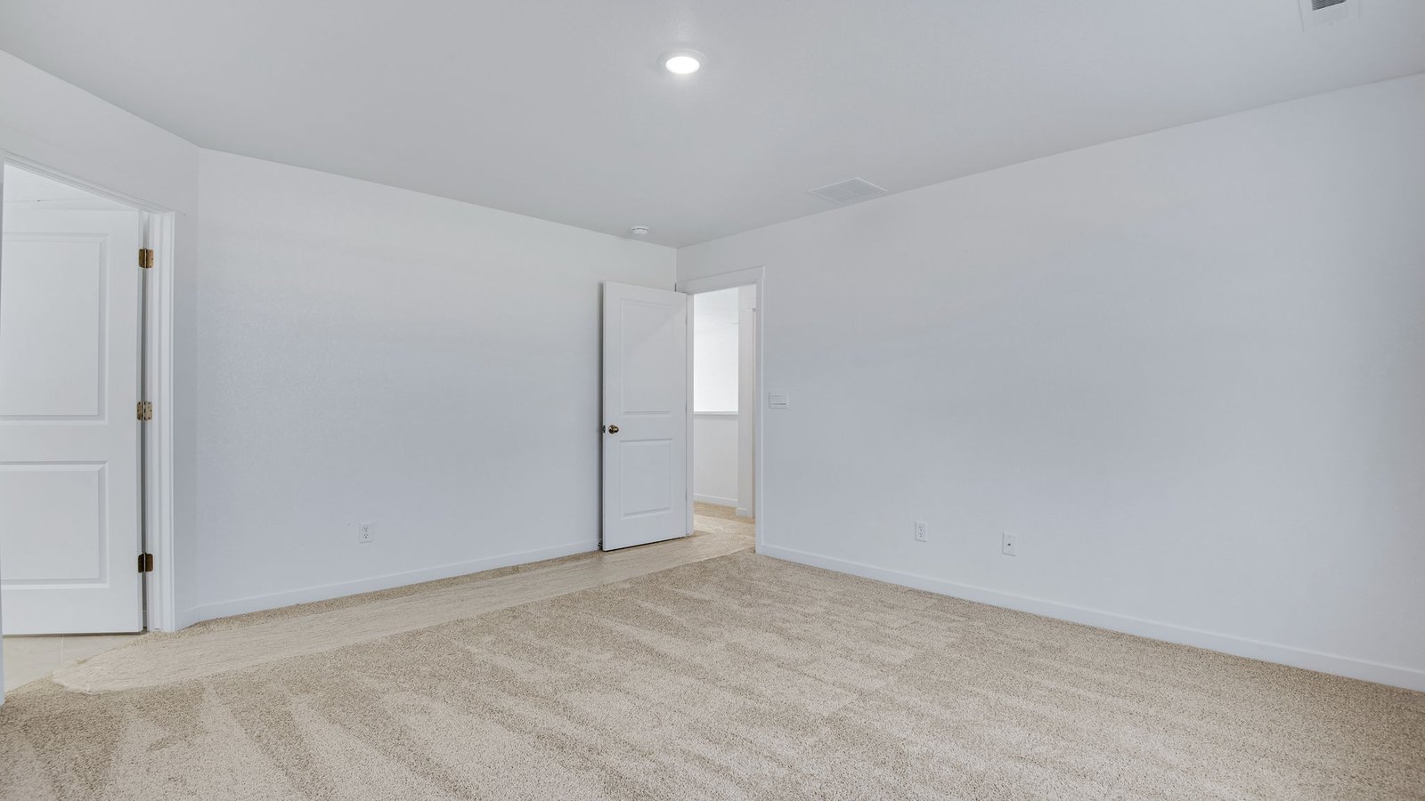 Spacious primary bedroom in new home at Spring Valley Ranch community