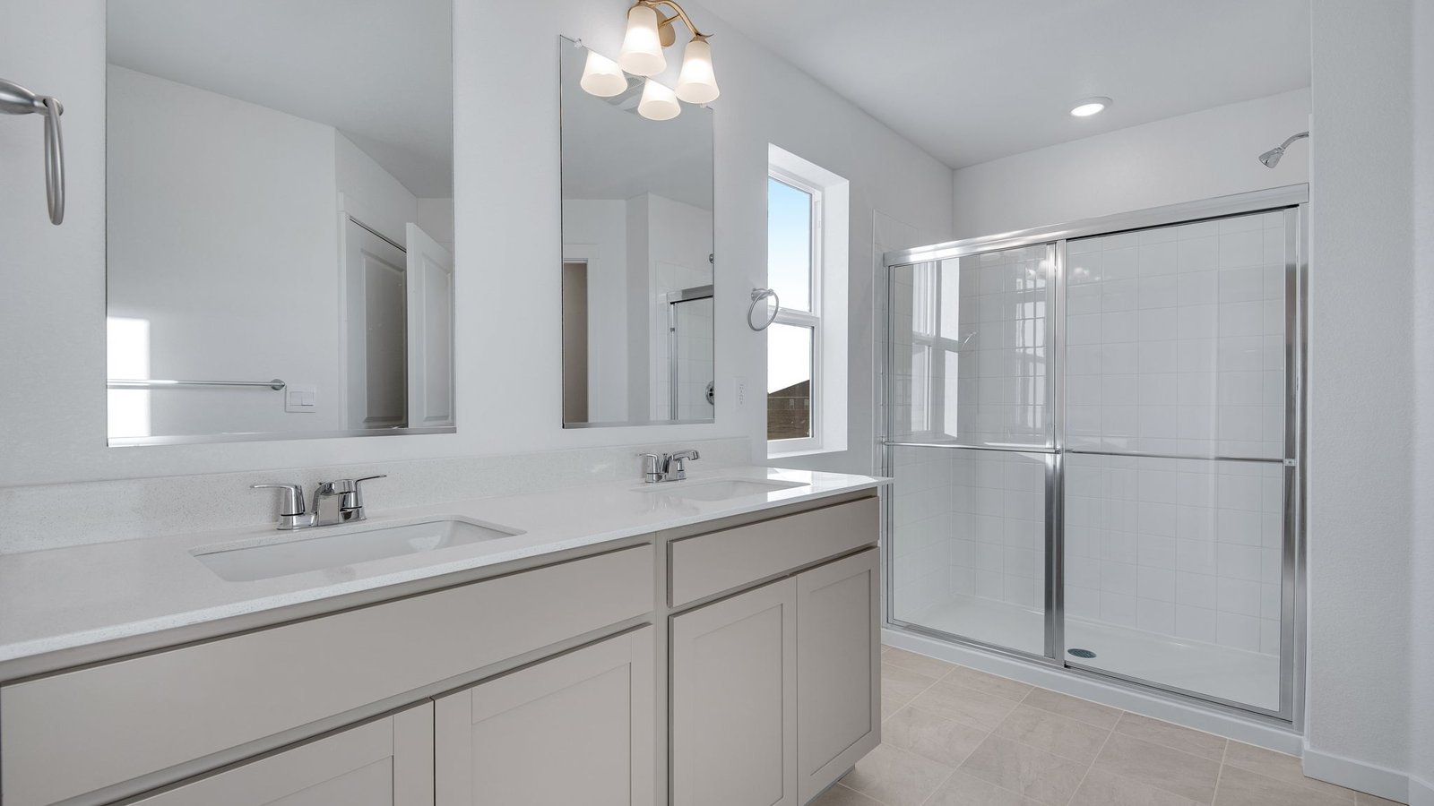 Private attached primary bathroom with dual vanity sink in new home in Elizabeth Colorado