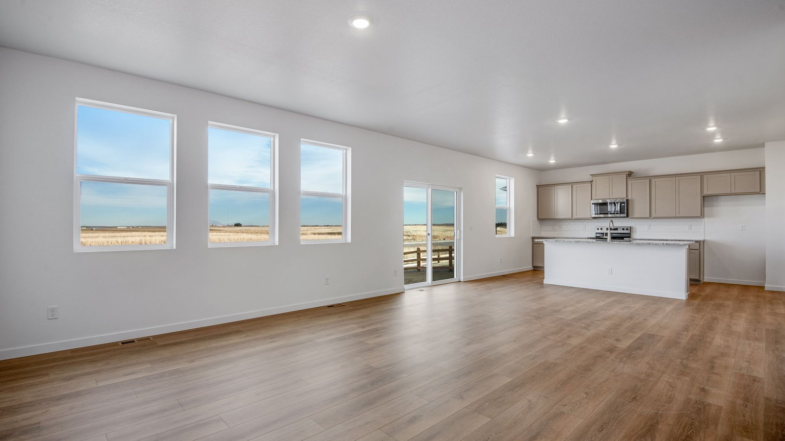 Open concept main floor layout with large windows in new D.R. Horton home in Colorado