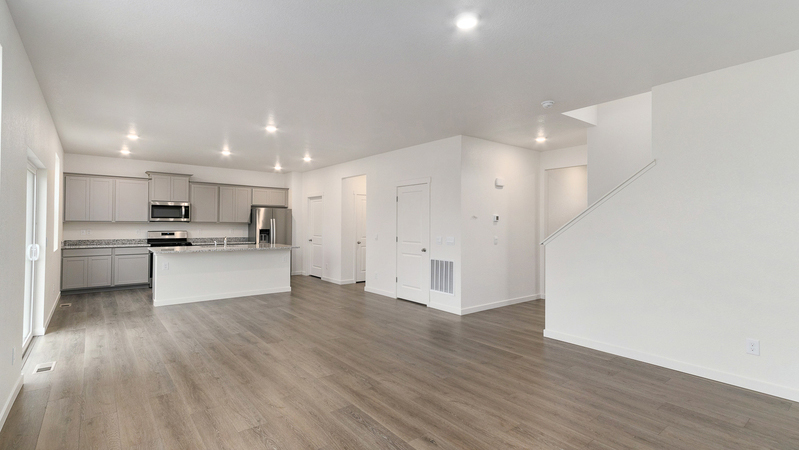 Open concept layout featuring kitchen with plenty of cabinet storage and an island for additional space