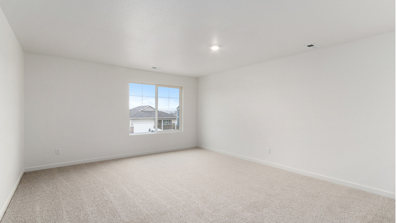 Spacious upstairs living area near top of stairwell with large window