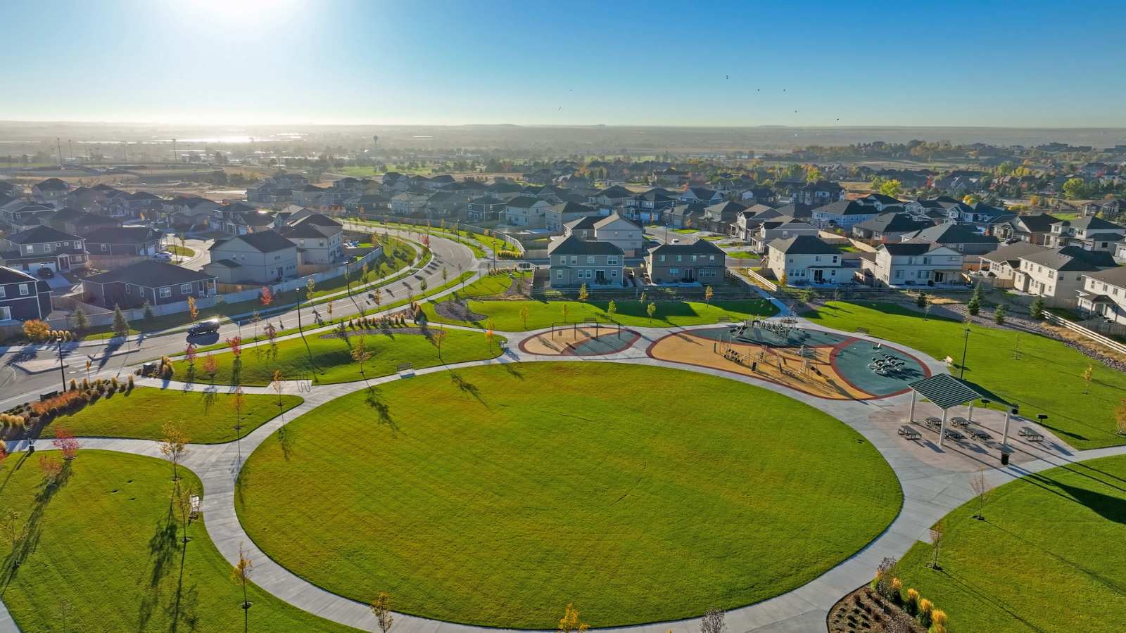 Large community park and gazebo beside a wide circular concrete path
