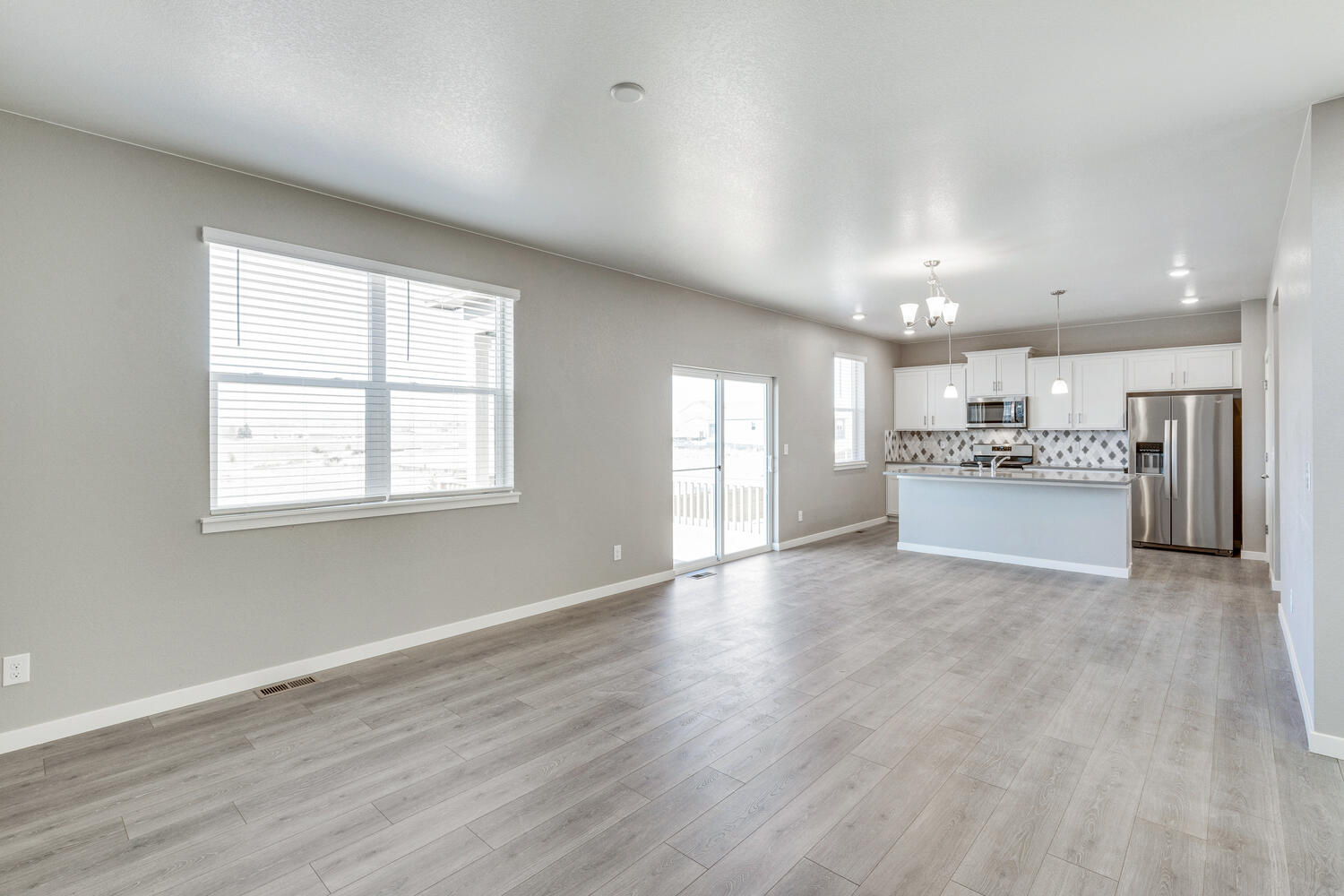 Open floor great room, nook, and kitchen with hardwood floors and 9' ceilings