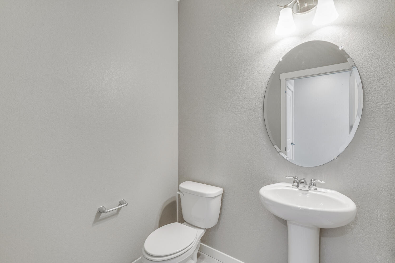 First floor powder room adjacent to the foyer and staircase