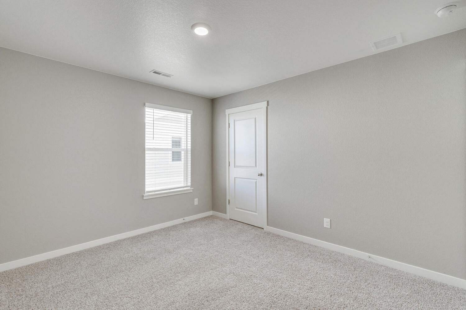 Bedroom 2 with side-facing window, closet, and ceiling affixed heating grate