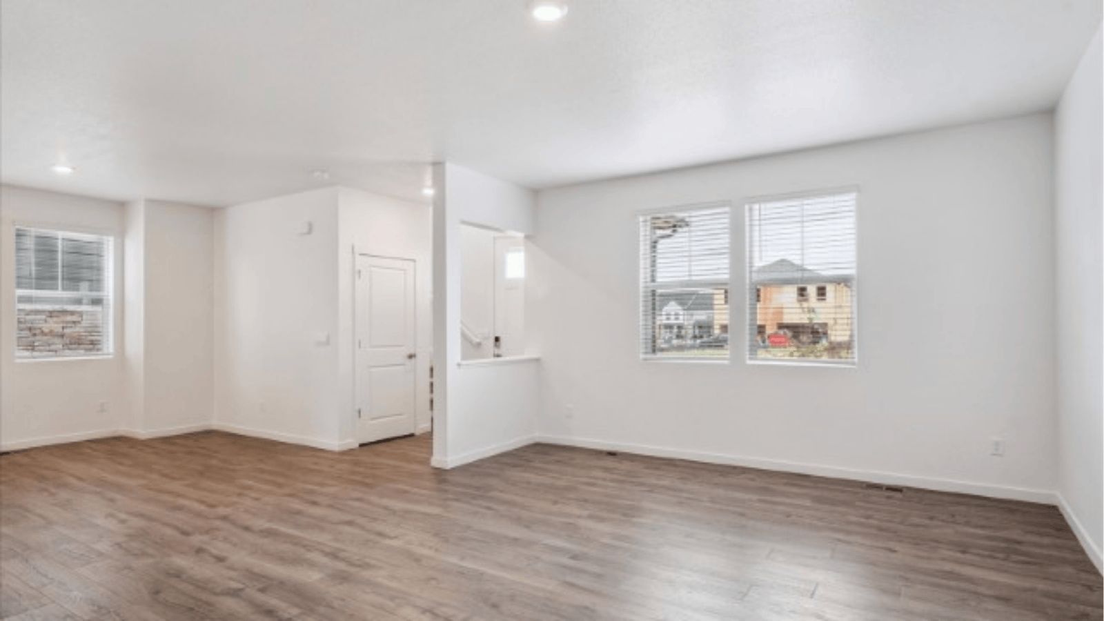 Open concept living space with large windows in new home community Horizon Uptown in Aurora