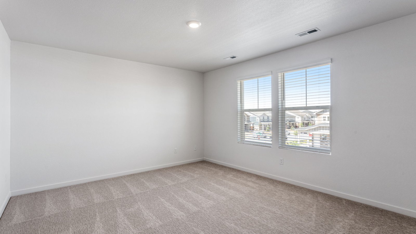Spacious primary bedroom with large windows in new Aurora colorado home