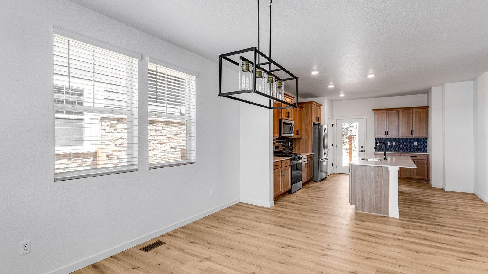 Open concept dining room with large windows in new D.R. Horton home in Aurora, Colorado