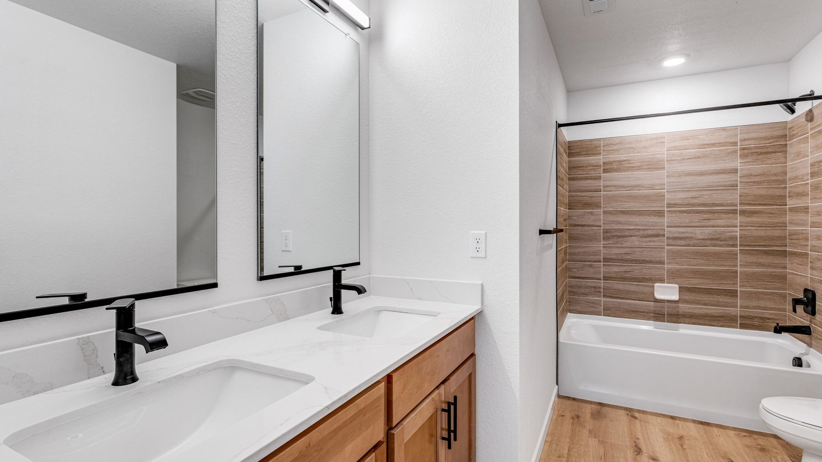 Secondary bathroom with dual vanity sinks in new home at Horizon Uptown community near DIA