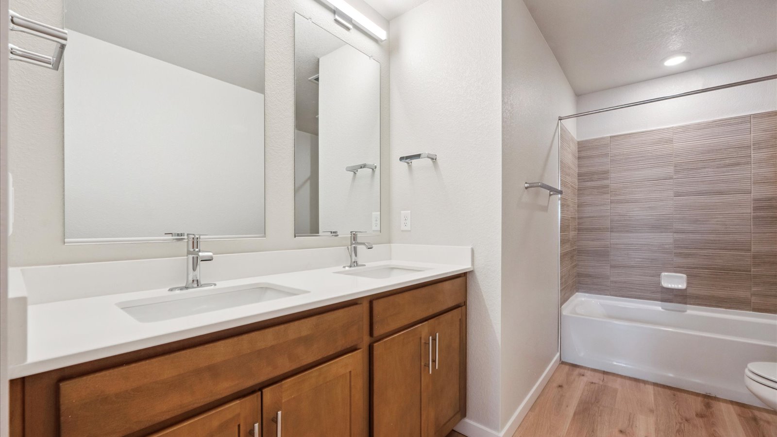 Additional bedroom in the Elbert floorplan suitable for guests, office, or flex use, with a closet and window.