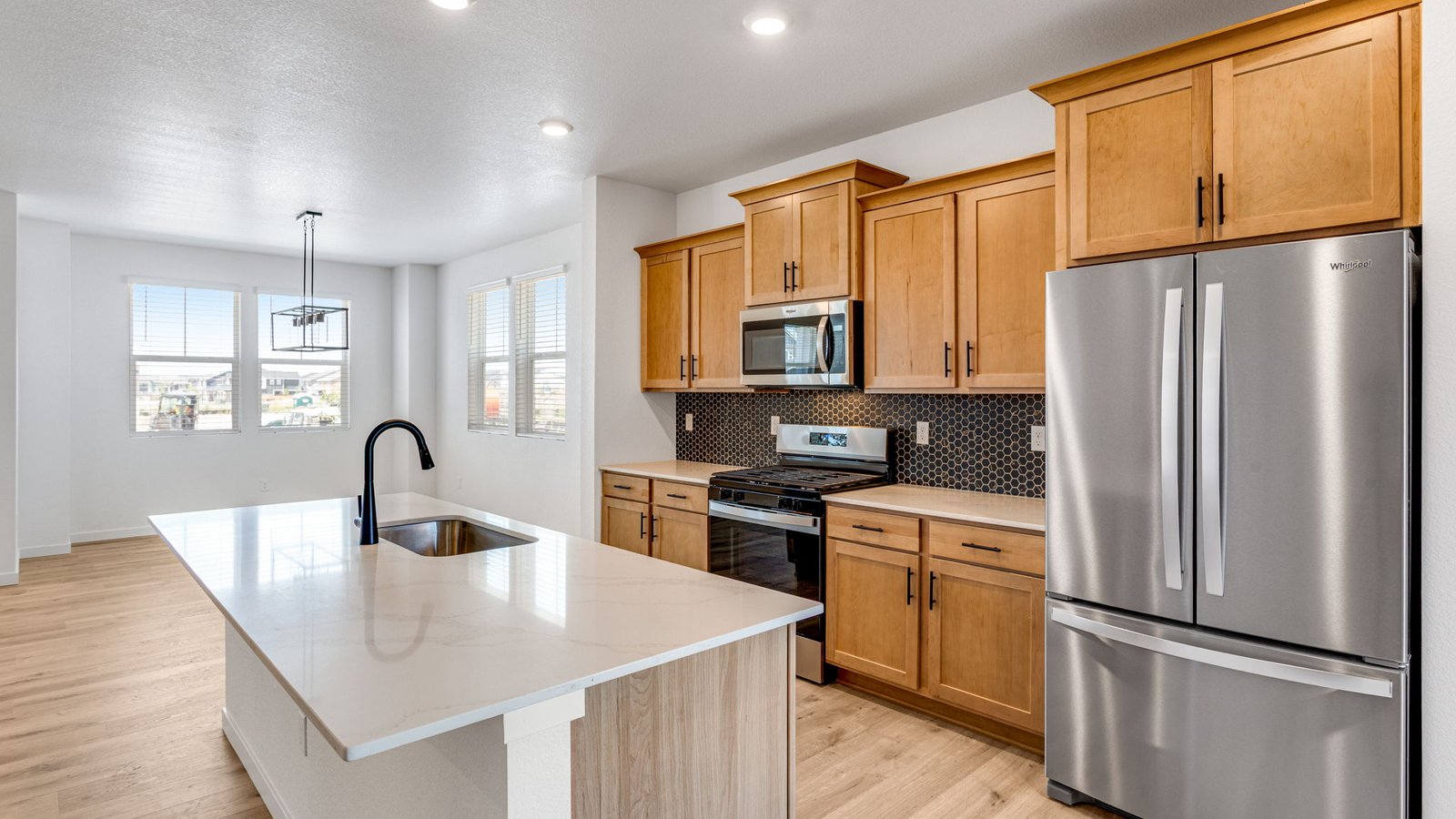 Kitchen with stainless steel appliances in new D.R. Horton home in Aurora, Colorado