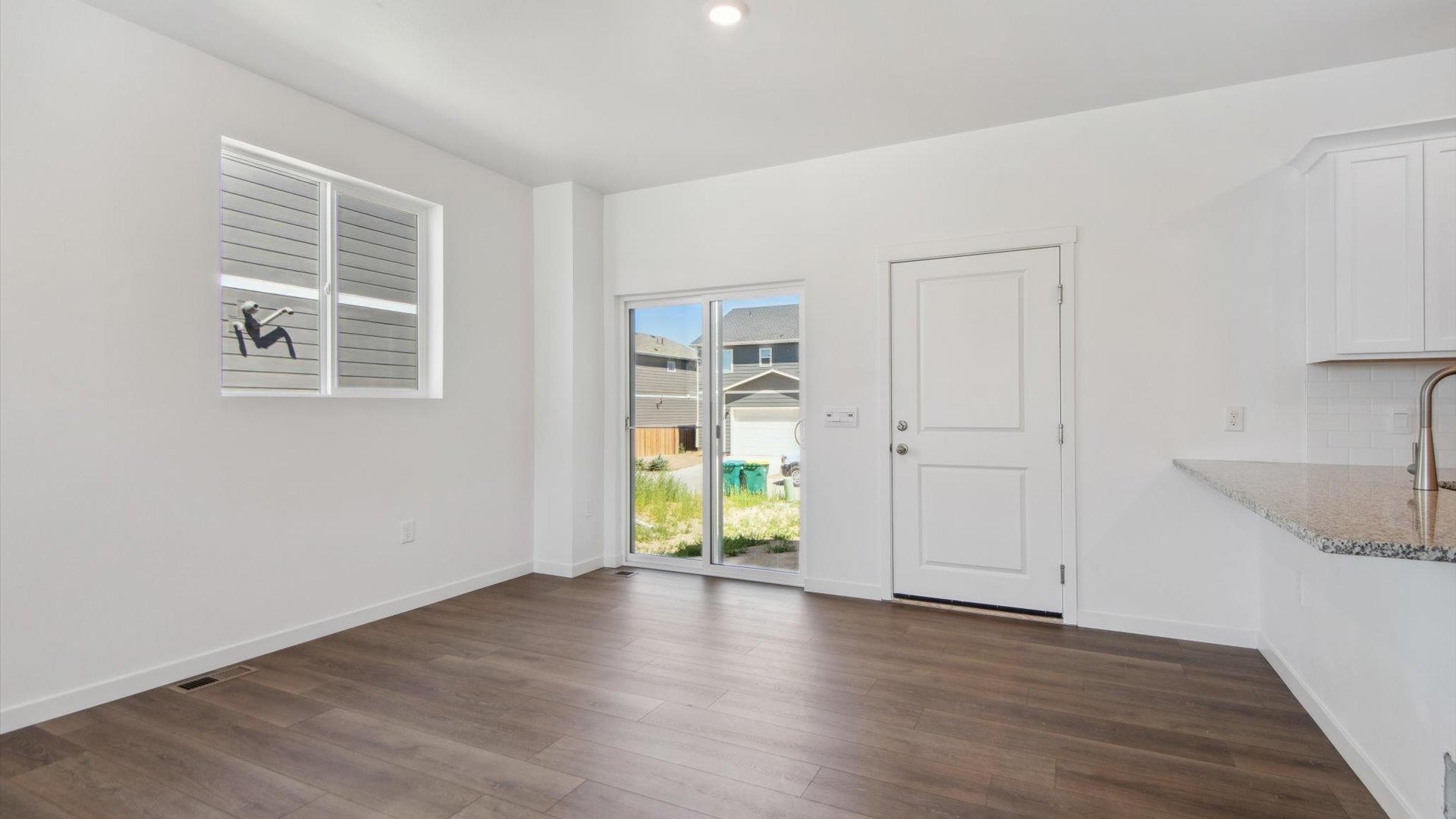 Expansive, laminate hardwoods fill the formal dining space in the Douglas, with casual eating option at the kitchen peninsula