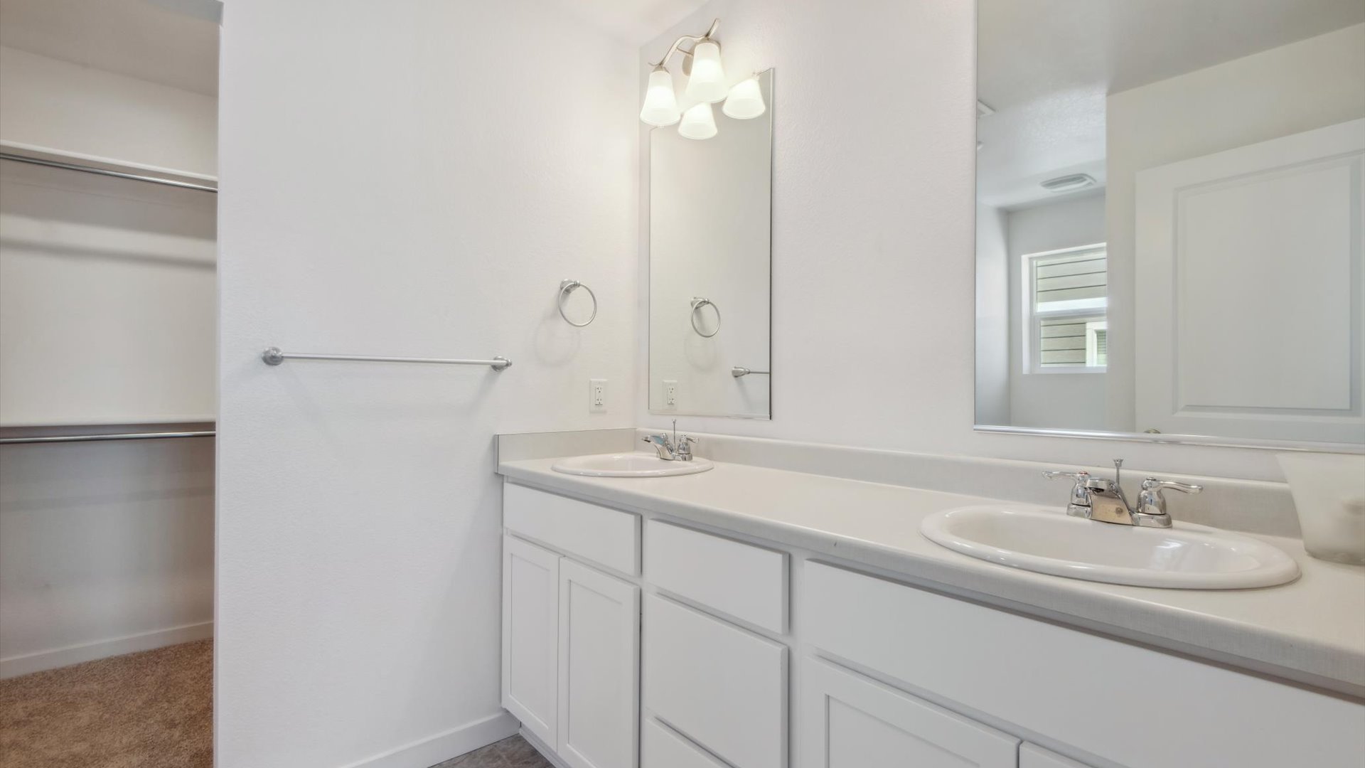 Douglas home design private bathroom featuring large double sink vanity with generous cabinets and drawers, with two mirrors