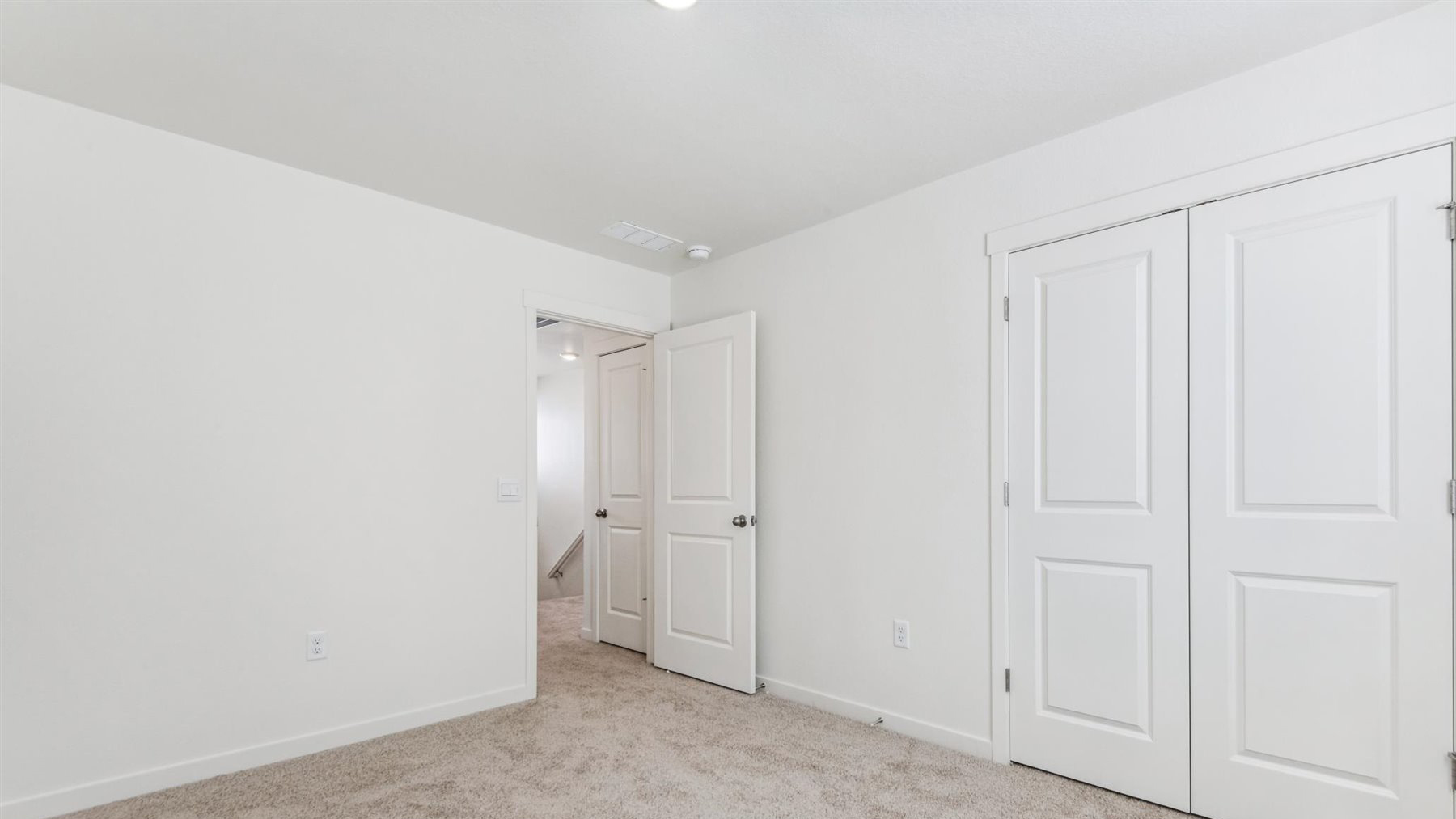 Elbert floor plan secondary bedroom #4 reverse view facing entry door and double-door storage closet with LED lighting above