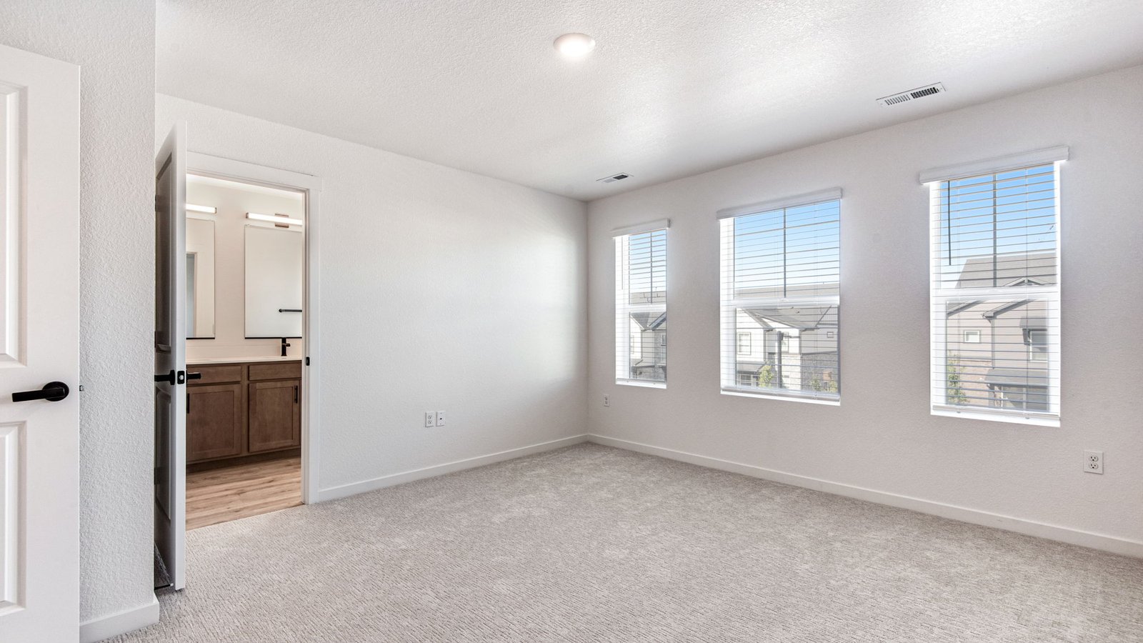 Primary bedroom in Muirfield floor plan featuring a spacious layout and contemporary finishes.