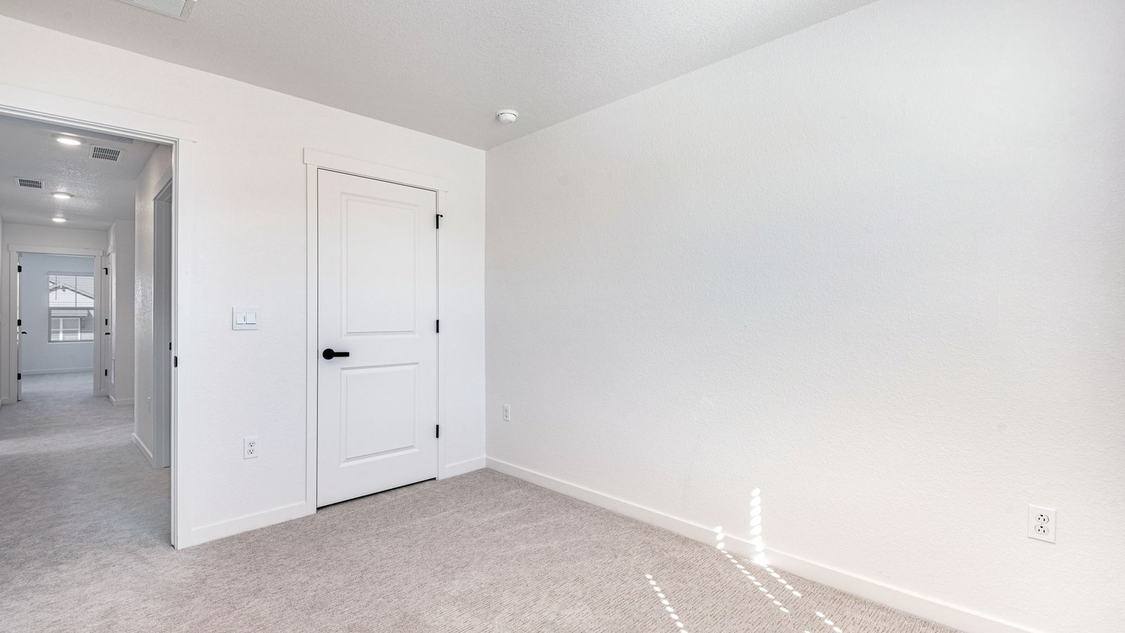 Light-filled bedroom with clean lines and modern design in Horizon Uptown home.