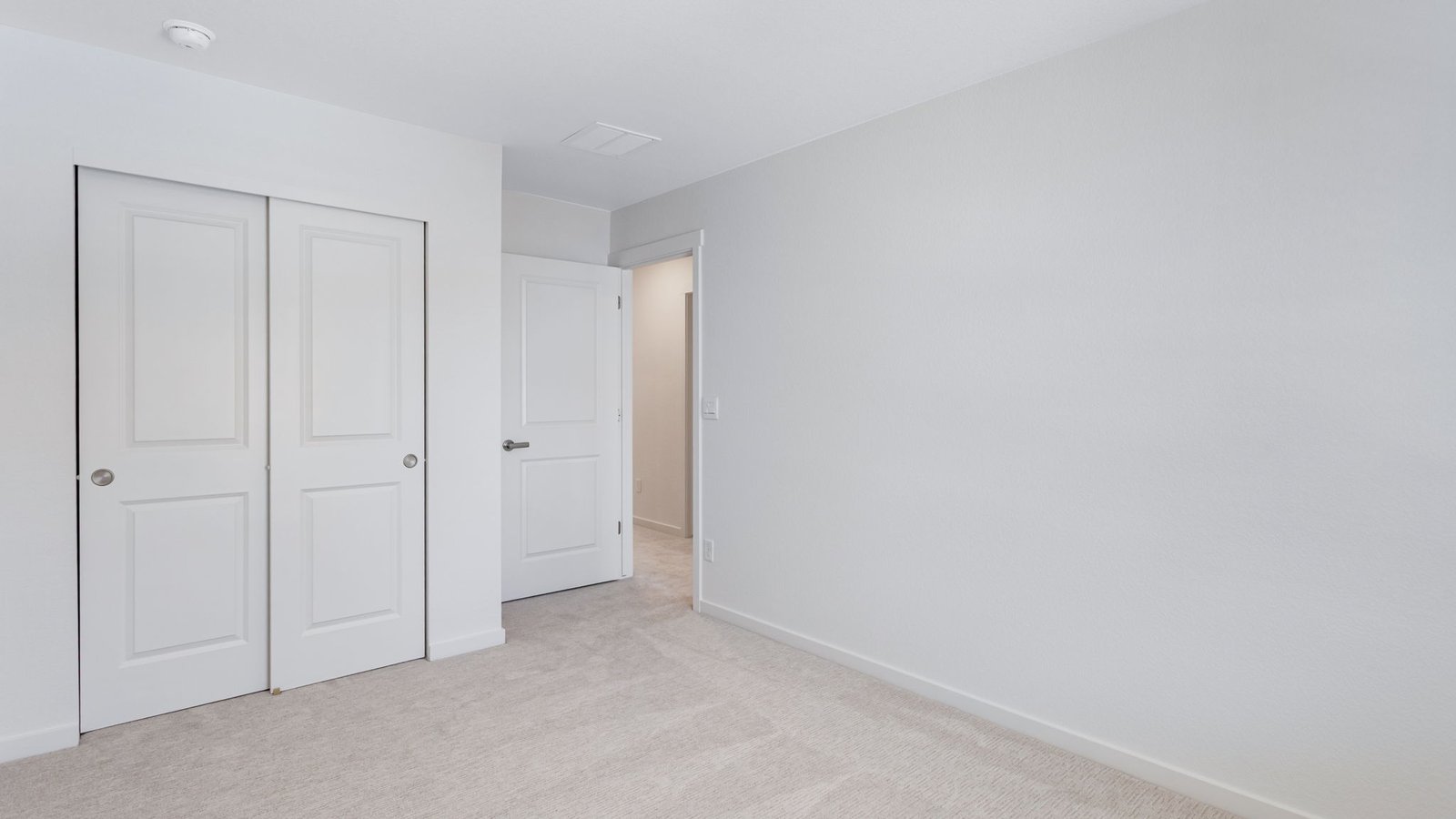 Secondary bedroom with generous closet space in Horizon Uptown community new home