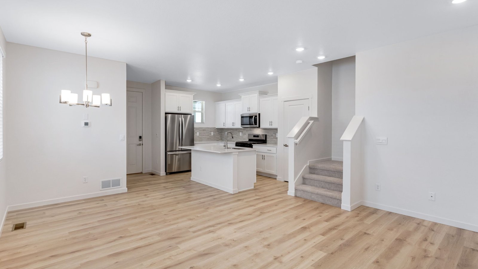 Open concept main floor layout of new Muirfield floor plan at Horizon Uptown community in Aurora, Colorado
