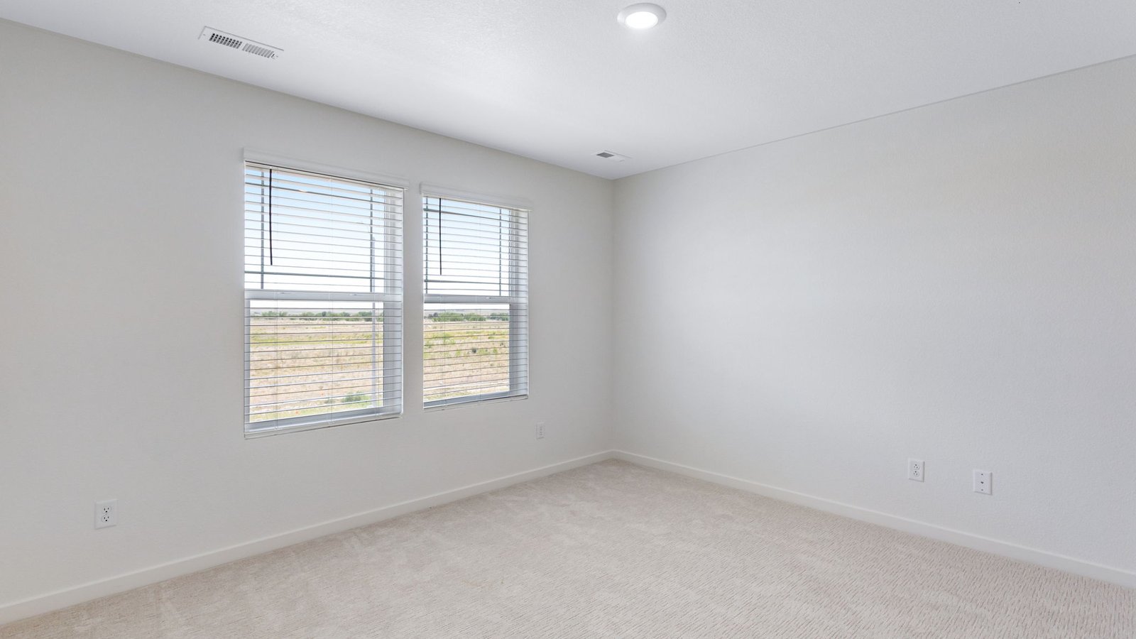 Primary bedroom with large windows in new home near Denver International Airport