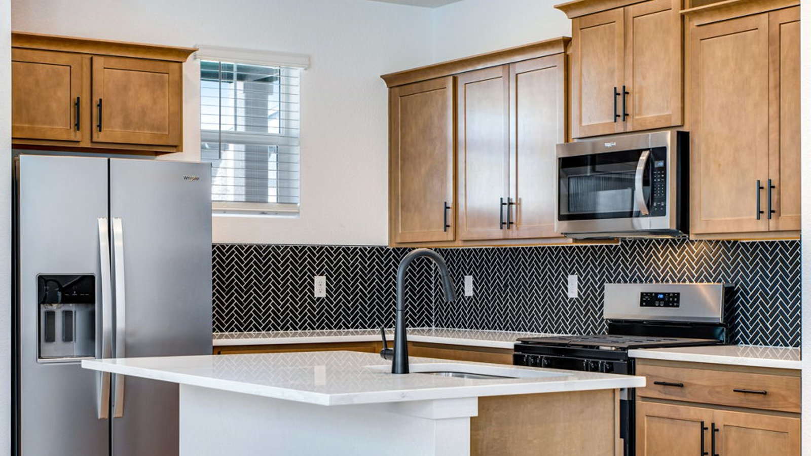 kitchen with brown cabinets and black finishes