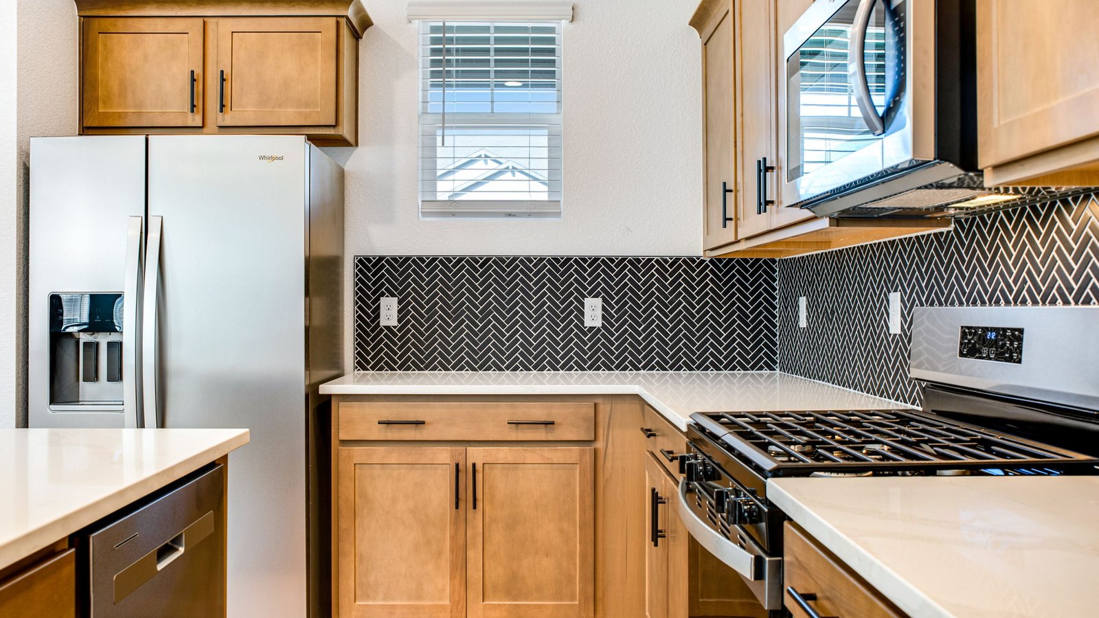 brown cabinets with black backsplash