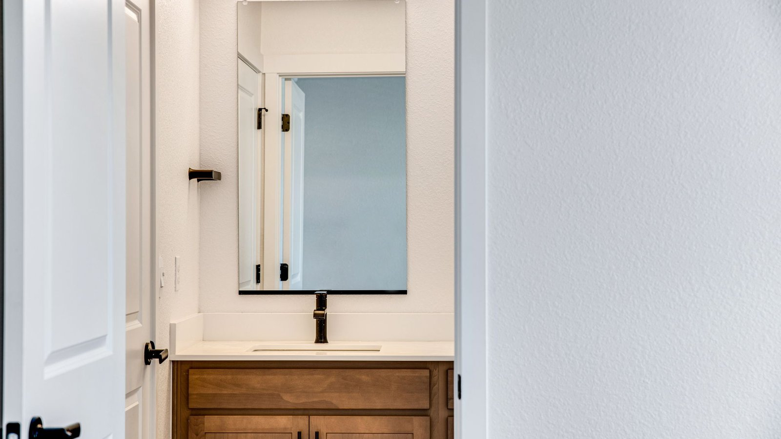 guest bathroom with black finishes in new D.R. Horton home