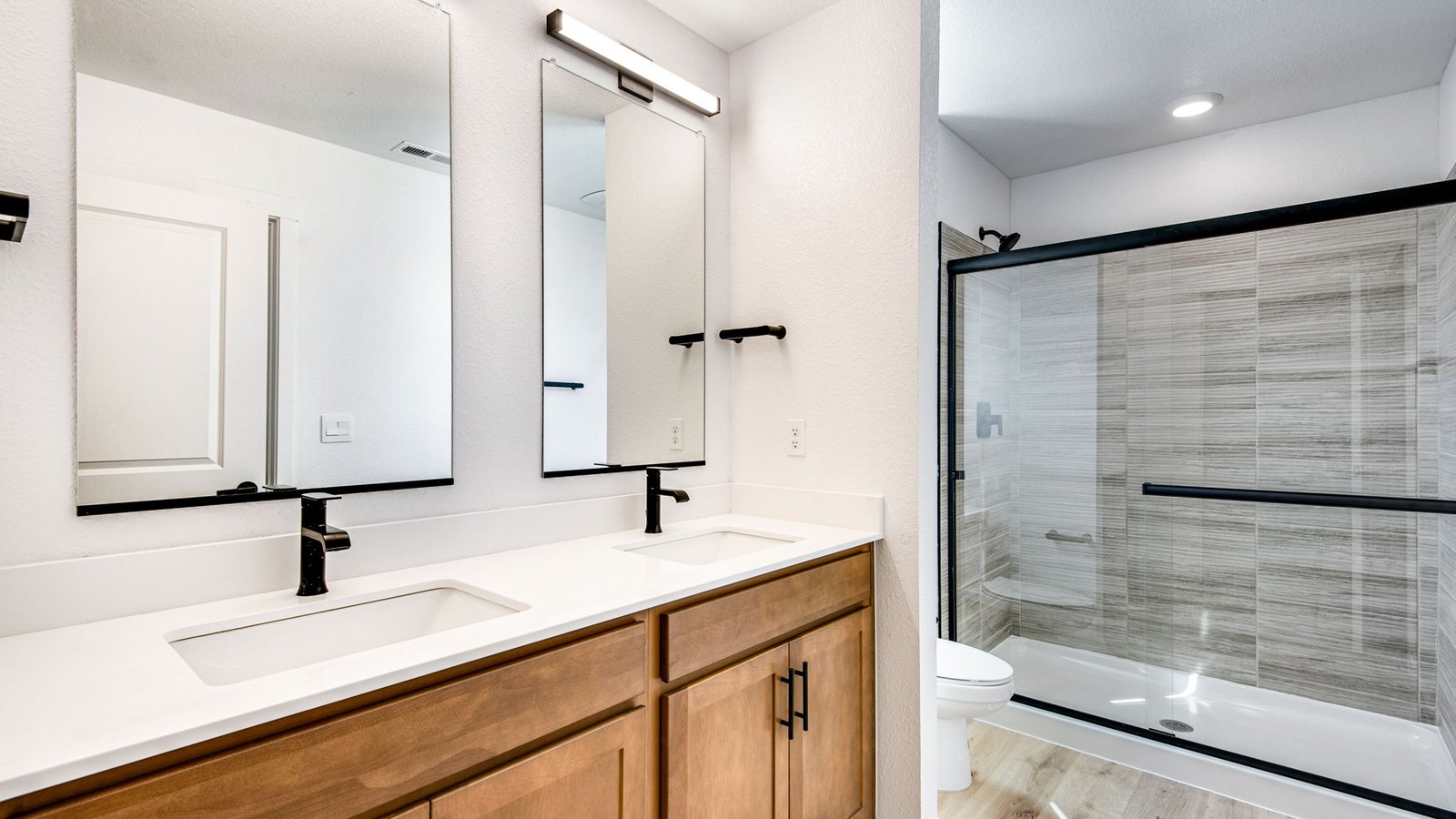 primary bathroom with black fixtures and shower