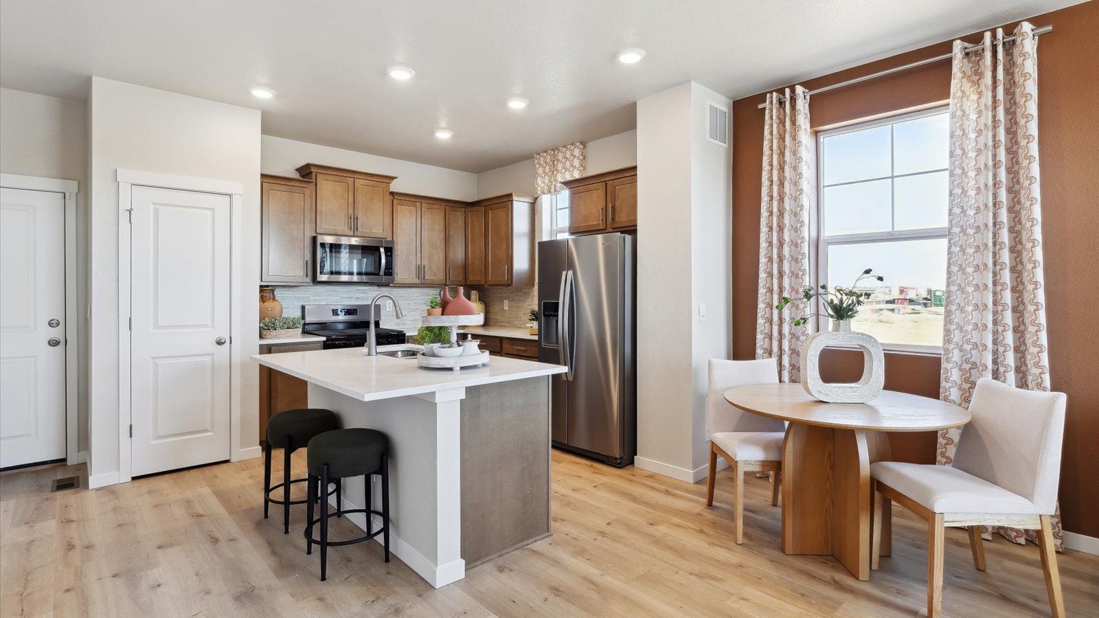 Bright Augusta kitchen with large island, pendant lighting, and seamless flow into the dining and living areas