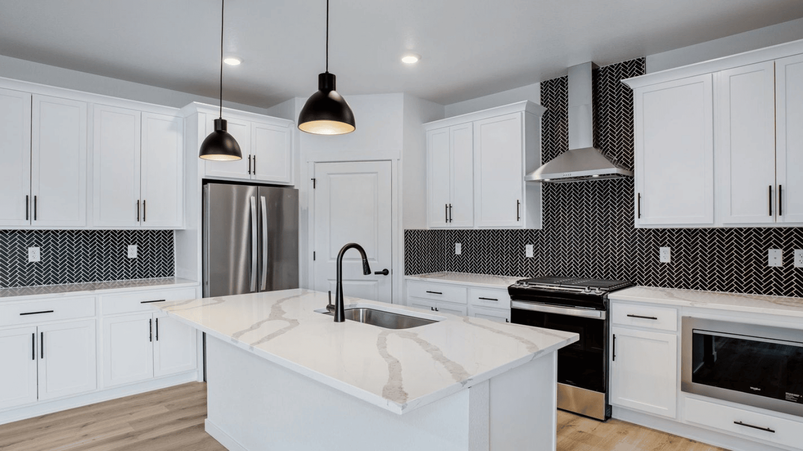 Modern kitchen with white cabinets in new D.R. Horton Hansen Farm community home in Fort Collins, CO