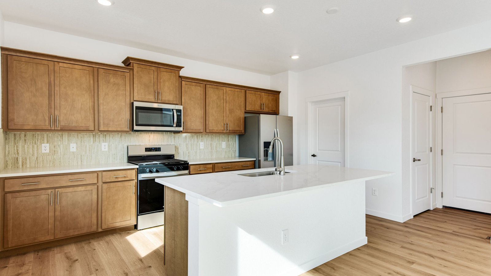 modern kitchen with wood cabinets in new home
