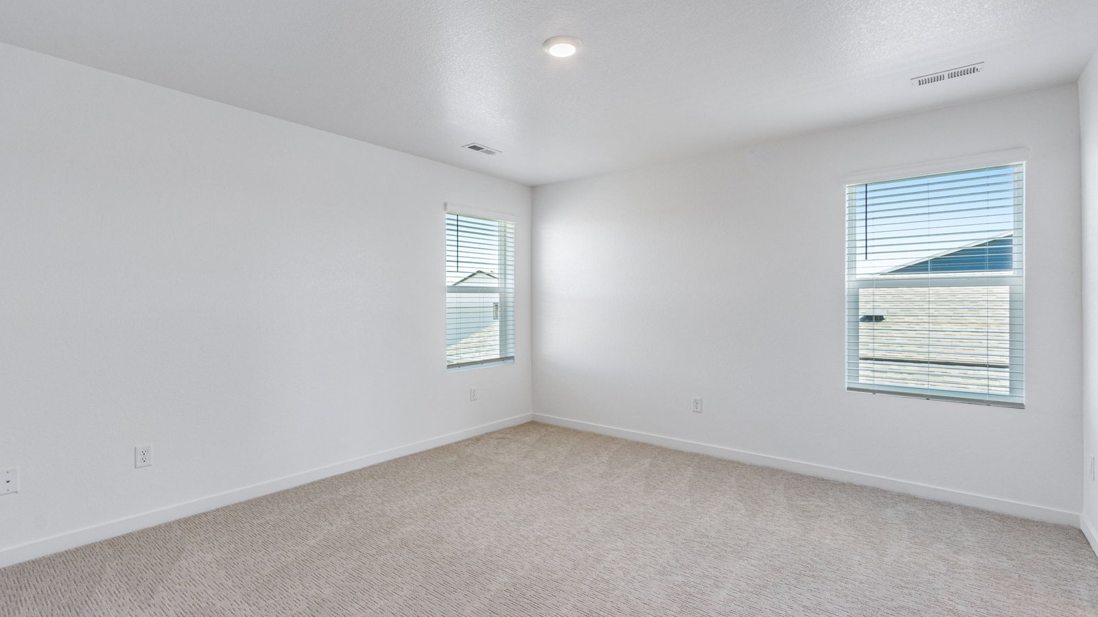 Private primary bedroom in the Edmon floor plan featuring a spacious layout and convenient access to the ensuite bathroom.