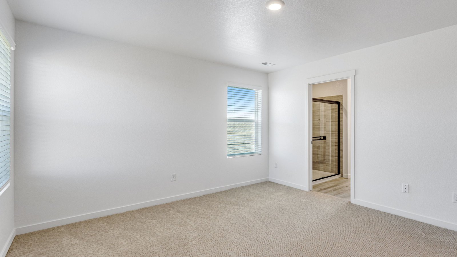 Large primary suite in the Edmon home designed for comfort, privacy, and everyday relaxation.