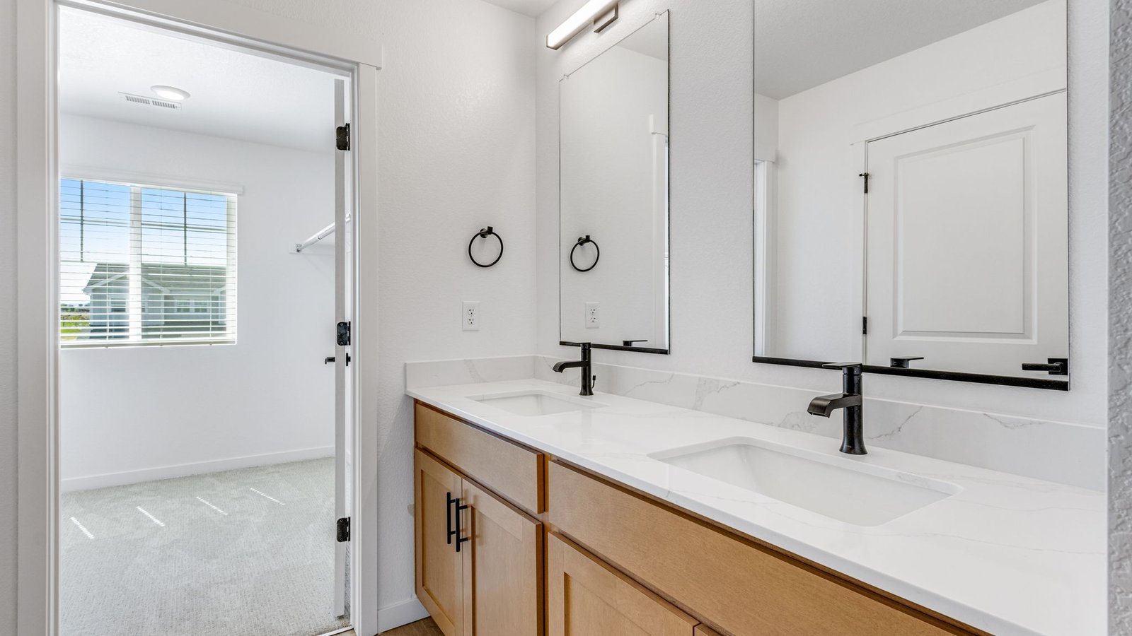Primary bathroom in the Edmon floor plan featuring dual vanities and a designer-inspired layout.