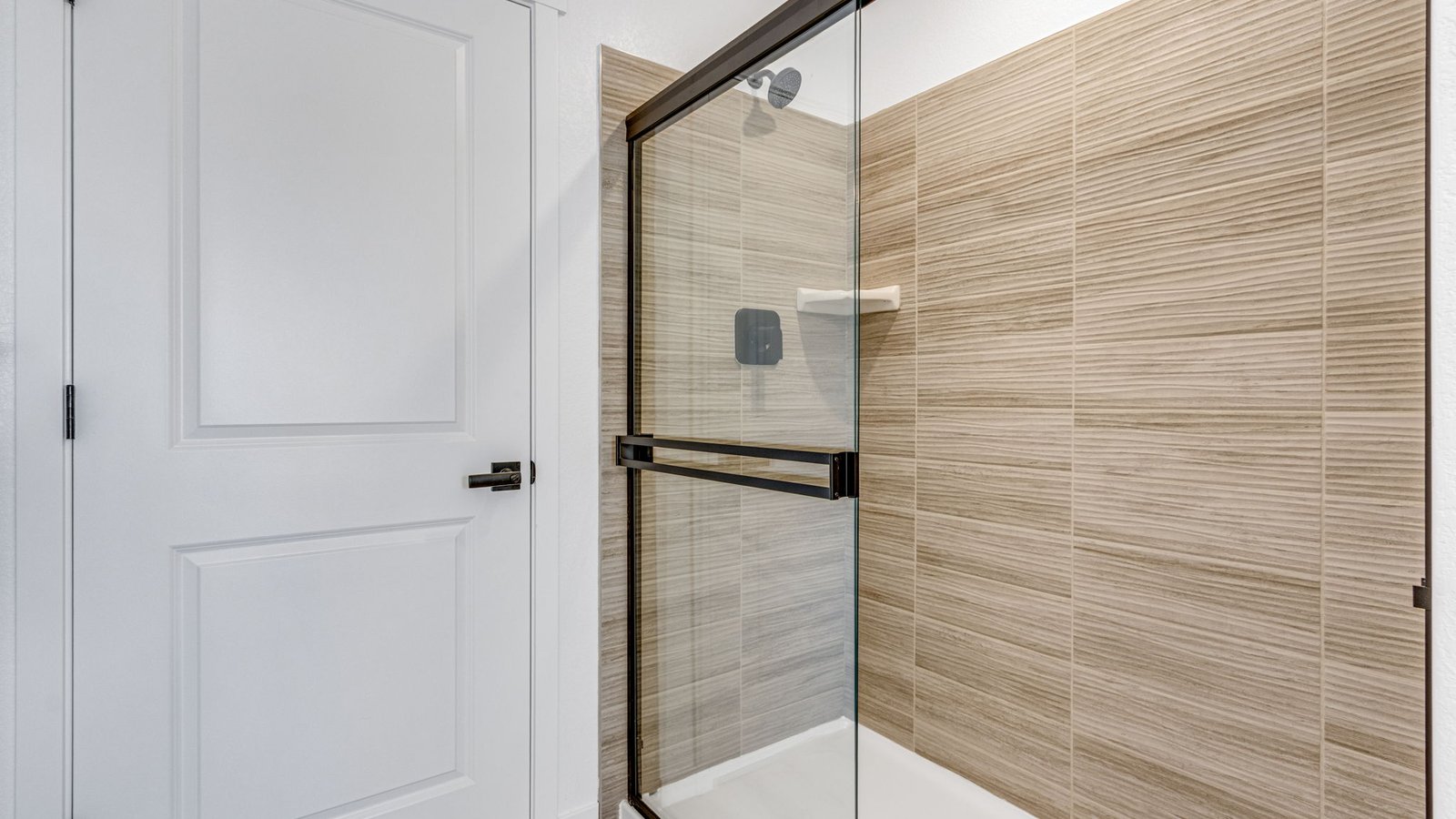 Spacious owner's bath in the Edmon home with double sinks, modern finishes, and convenient storage.