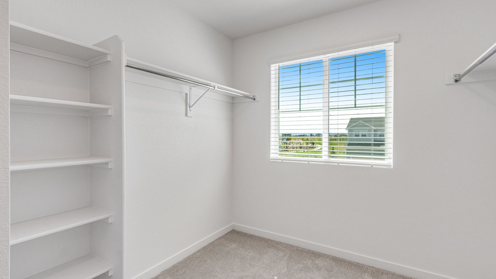Walk-in closet in the Edmon primary suite offering ample storage and organization space.