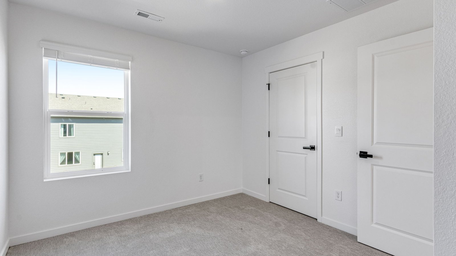 Secondary bedroom in the Edmon floor plan offering comfortable living space and flexible use options.