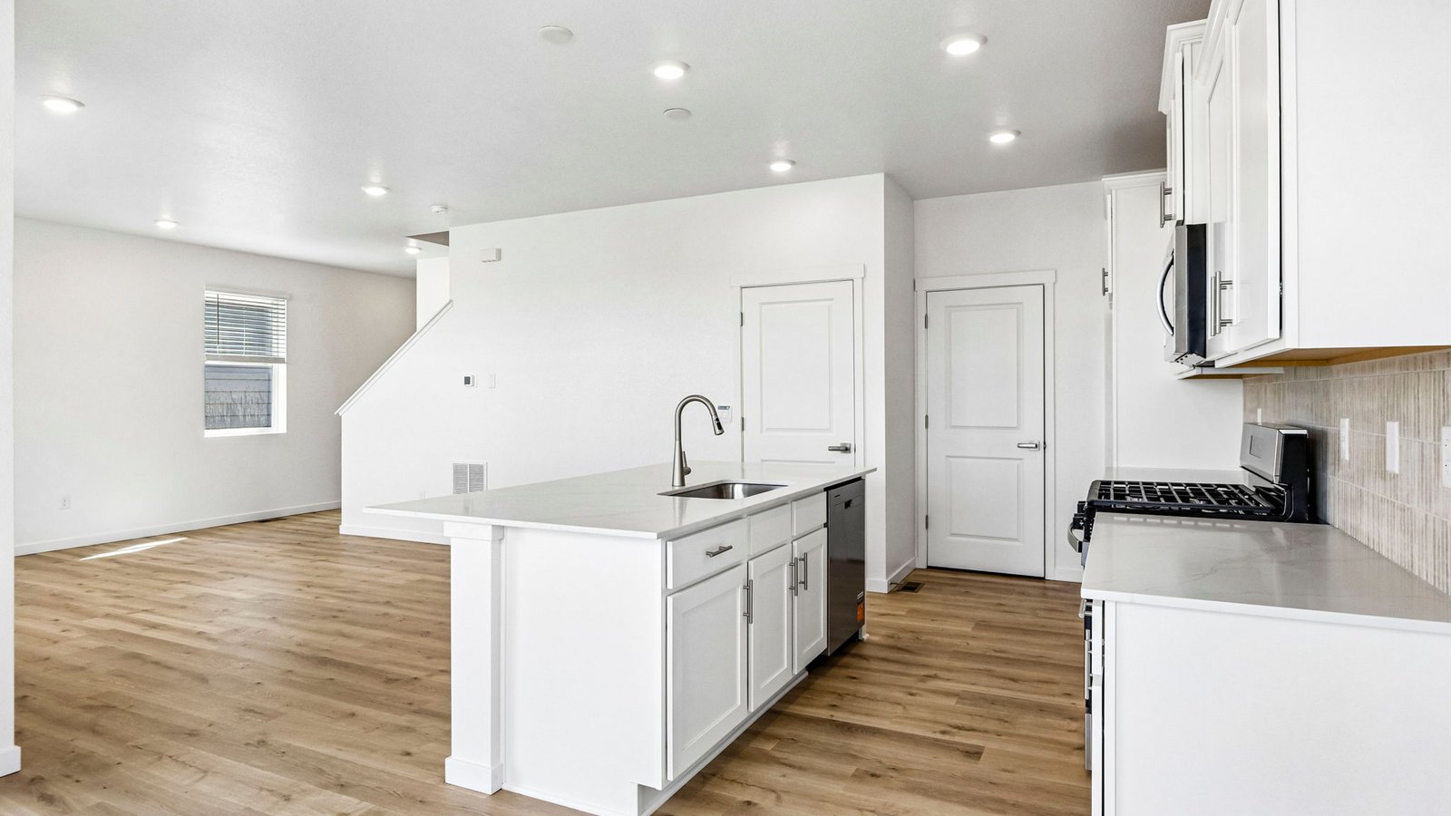 Open kitchen with stylish finishes and convenient layout overlooking the main living area.