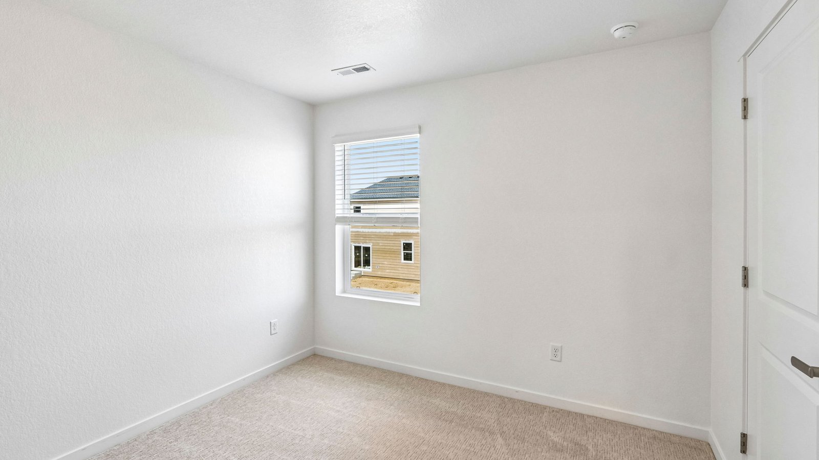 Comfortable secondary bedroom with natural light and versatile living space.