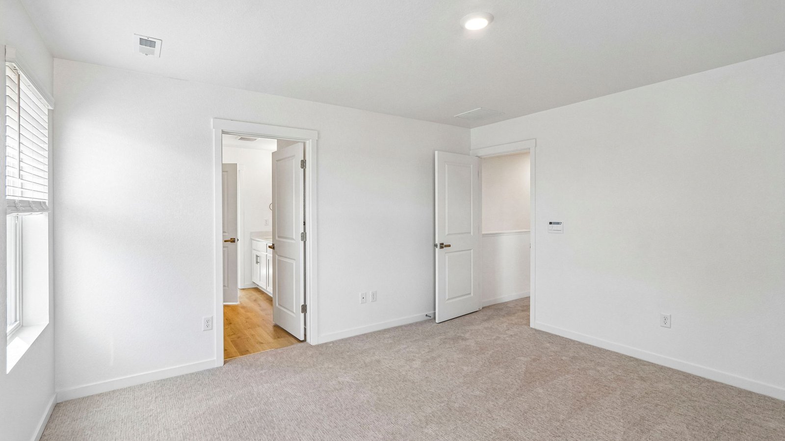 Private primary suite featuring a spacious layout and abundant natural light.