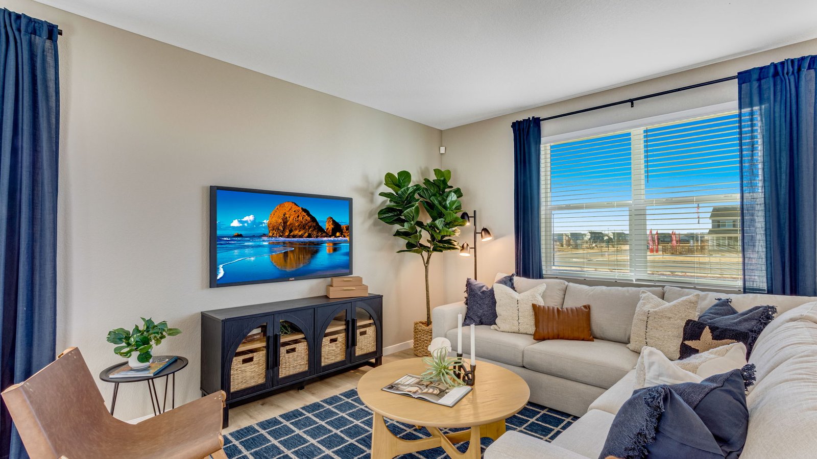 Open-concept living room in the Pine floor plan with abundant natural light and seamless flow to the kitchen and dining area.
