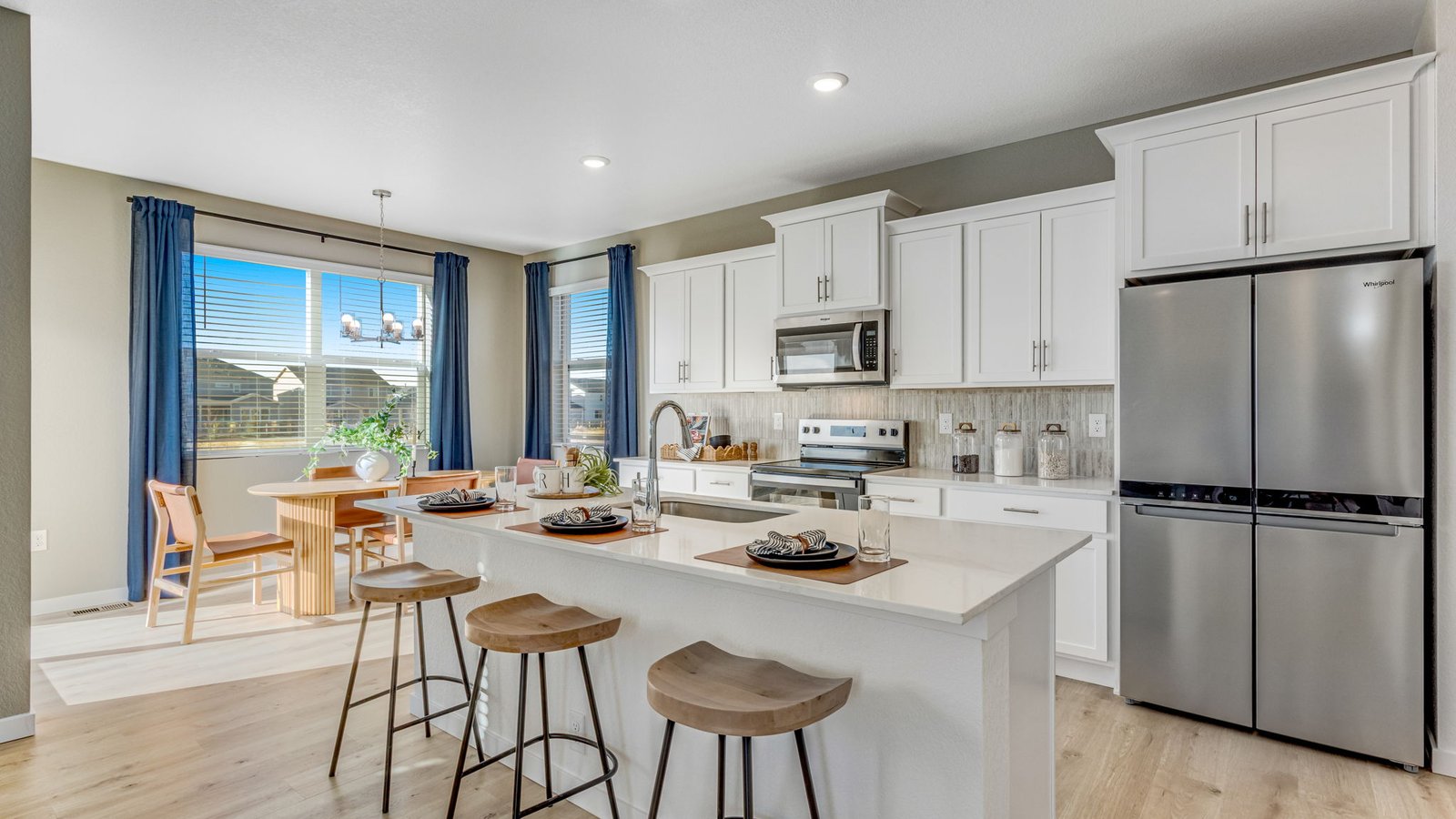 Modern kitchen in the Pine floor plan with stainless steel appliances, large center island, walk-in pantry, and ample counter space.