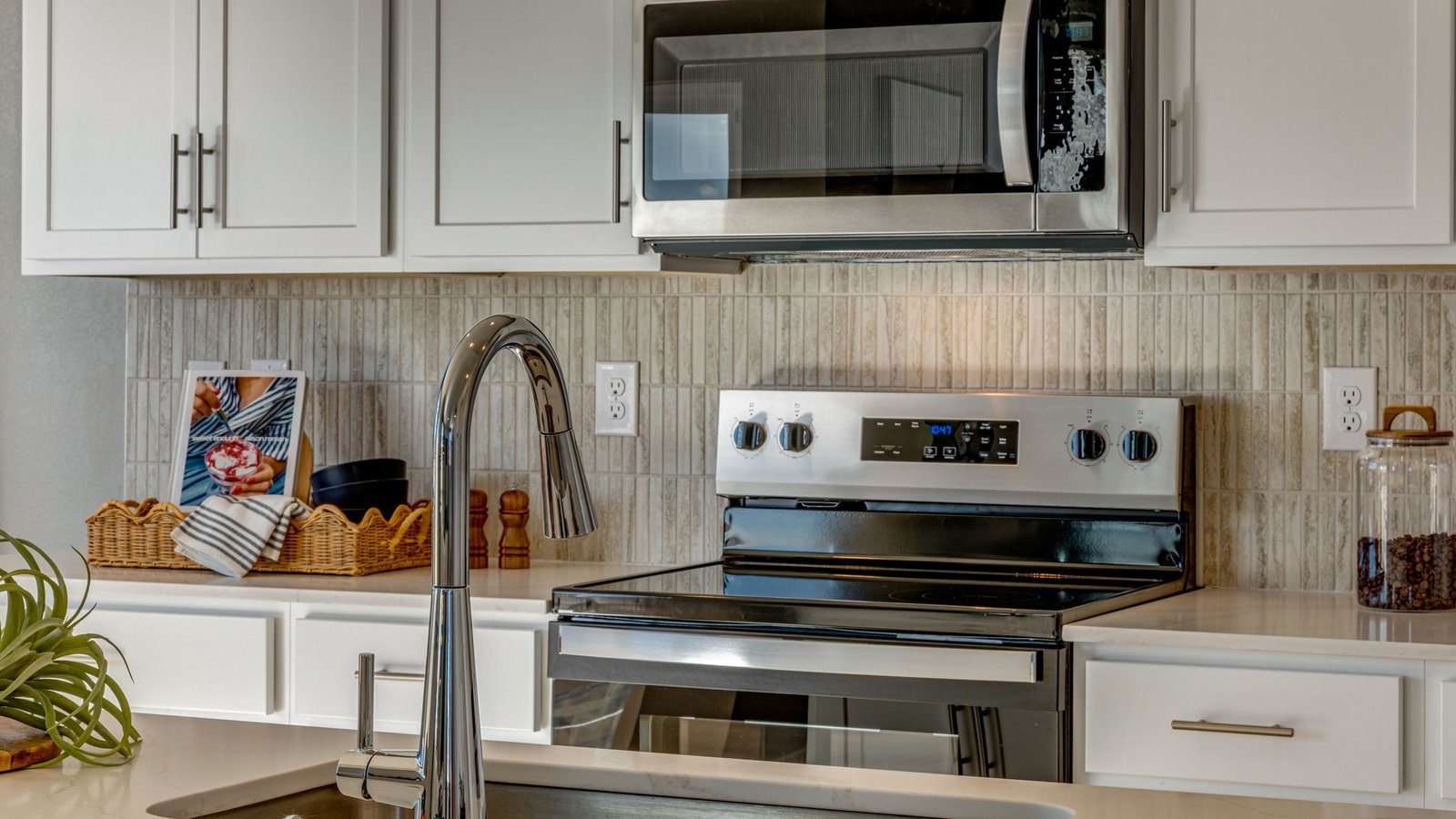 white cabinets and stainless steel appliances in kitchen of new windsor, co hom