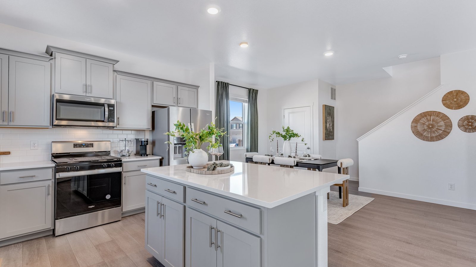 Bright kitchen with spacious island seating, durable solid surface flooring, and elegant finishes.