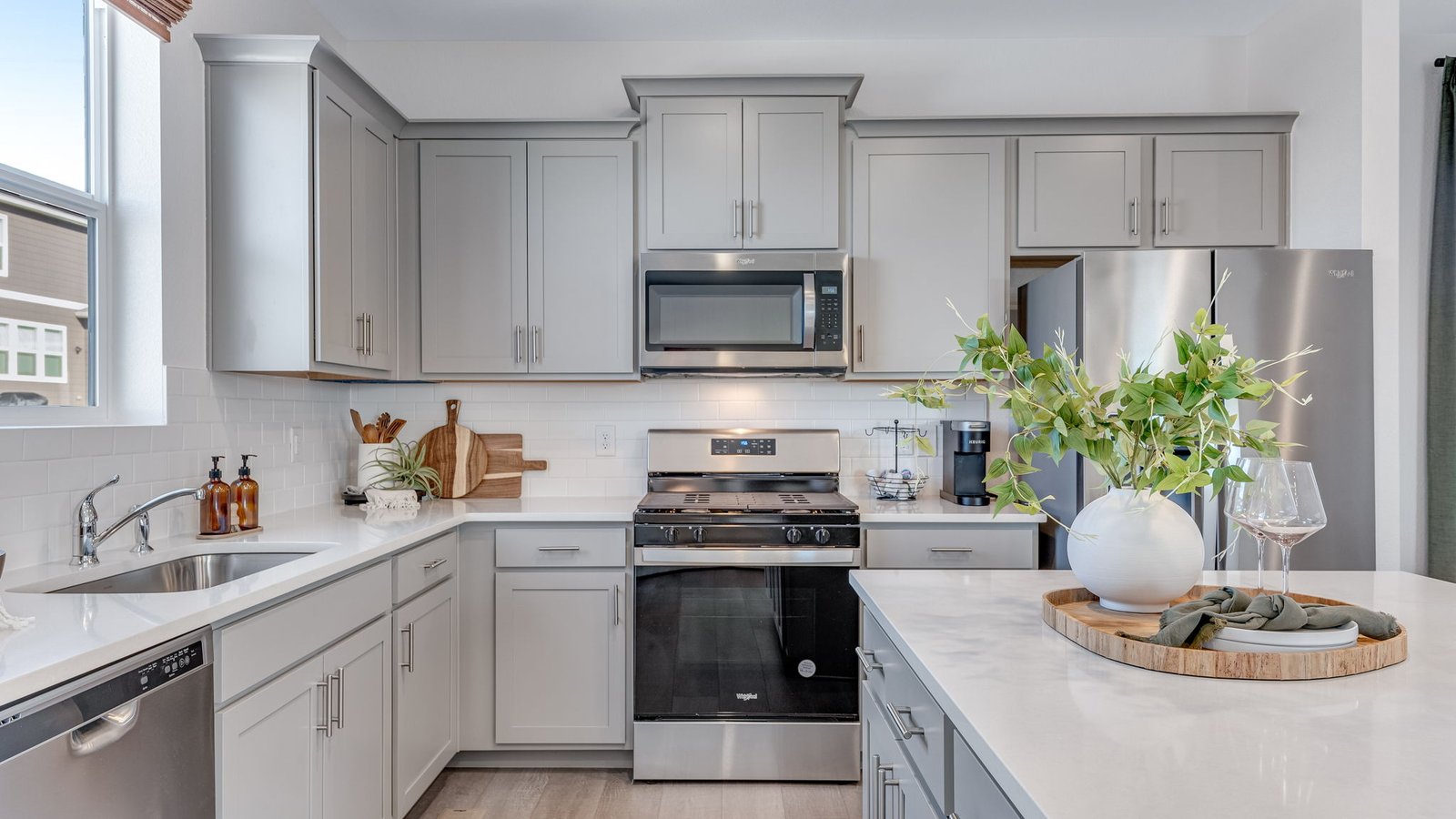 Open-concept kitchen featuring stainless steel appliances, an oversized island, and modern cabinetry.