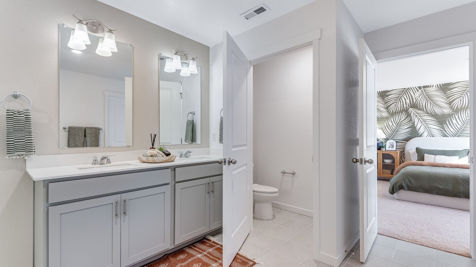 Spacious owner's bathroom featuring dual sinks and modern finishes.